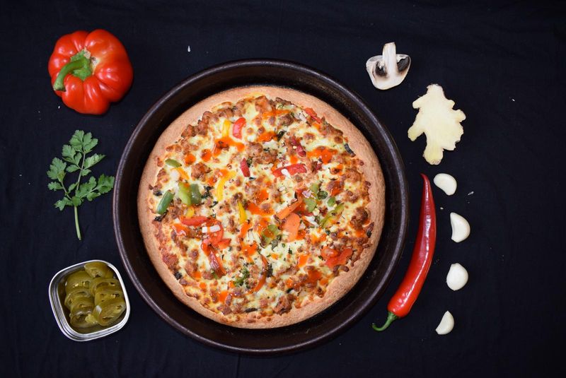 Pizza loaded with capsicum and a spiced topping